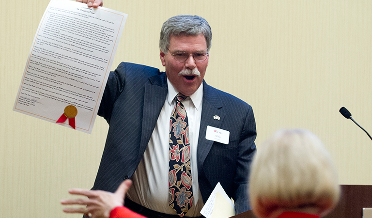Mike Patchner holding up a document