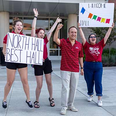Chancellor Paydar cheers with Residence Hall employees welcoming new students on Move-In Day 2018.