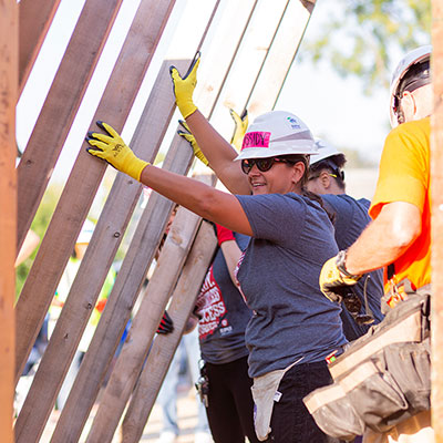 IUPUI volunteers lift a wall for the Habitat for Humanity build.