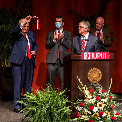 IU President Michael A. McRobbie shows the key to the audience during the Ball Residence Hall Rededication ceremony.