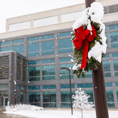IUPUI building with holiday wreath on a snowy day.