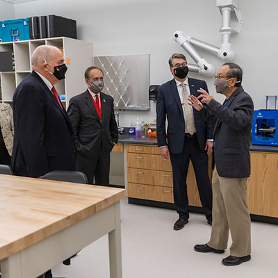 President McRobbie, Chancellor Paydar, Dean David Russomano enjoy a tour of Innovation Hall laboratory from an IUPUI faculty member. 