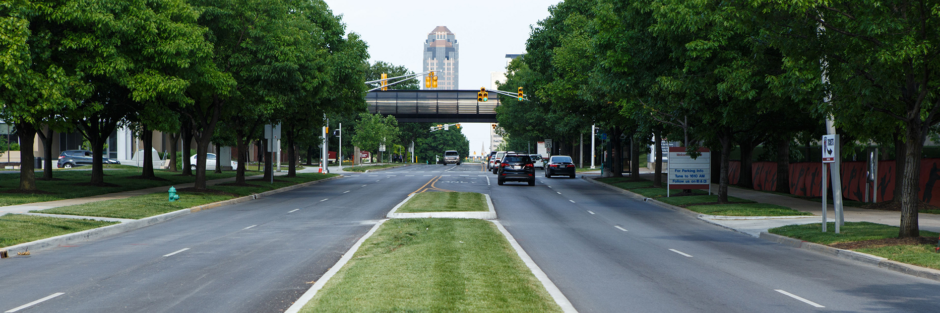 Newly constructed New York St. with grassy median and bike trail