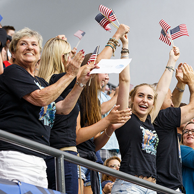 people cheering at the olympic diving trials